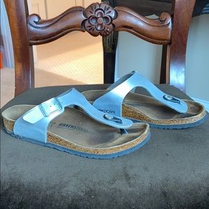 Kids silver Birkenstock flip-flops.